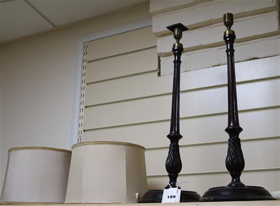 A pair of Georgian style brass mounted mahogany candlesticks height 54cm